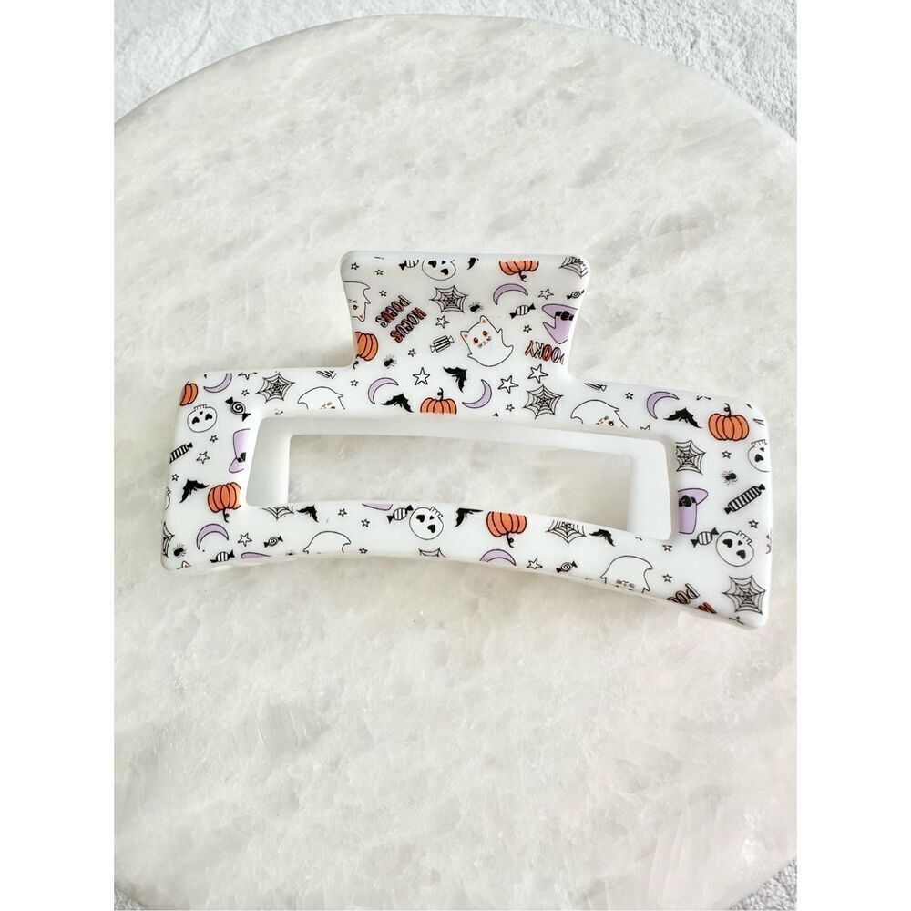 Halloween mixed print hair claw with pumpkin, moon, spiderweb, ghost, and stars